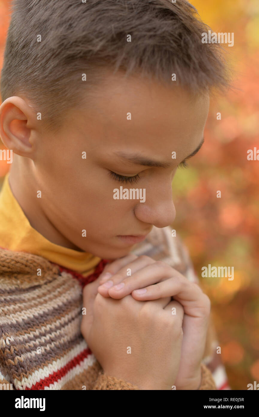 Portrait of a sad little boy outdoors Stock Photo