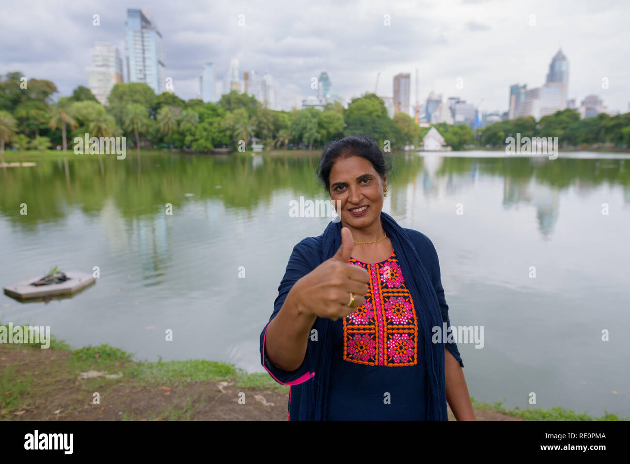 Mature beautiful Indian woman giving thumb up Stock Photo