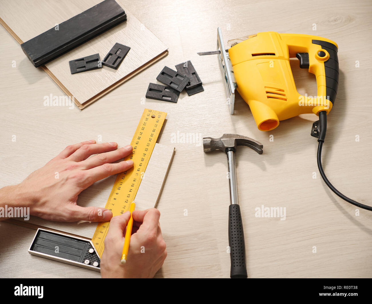 Crop worker measuring plank while making floor layering with ...