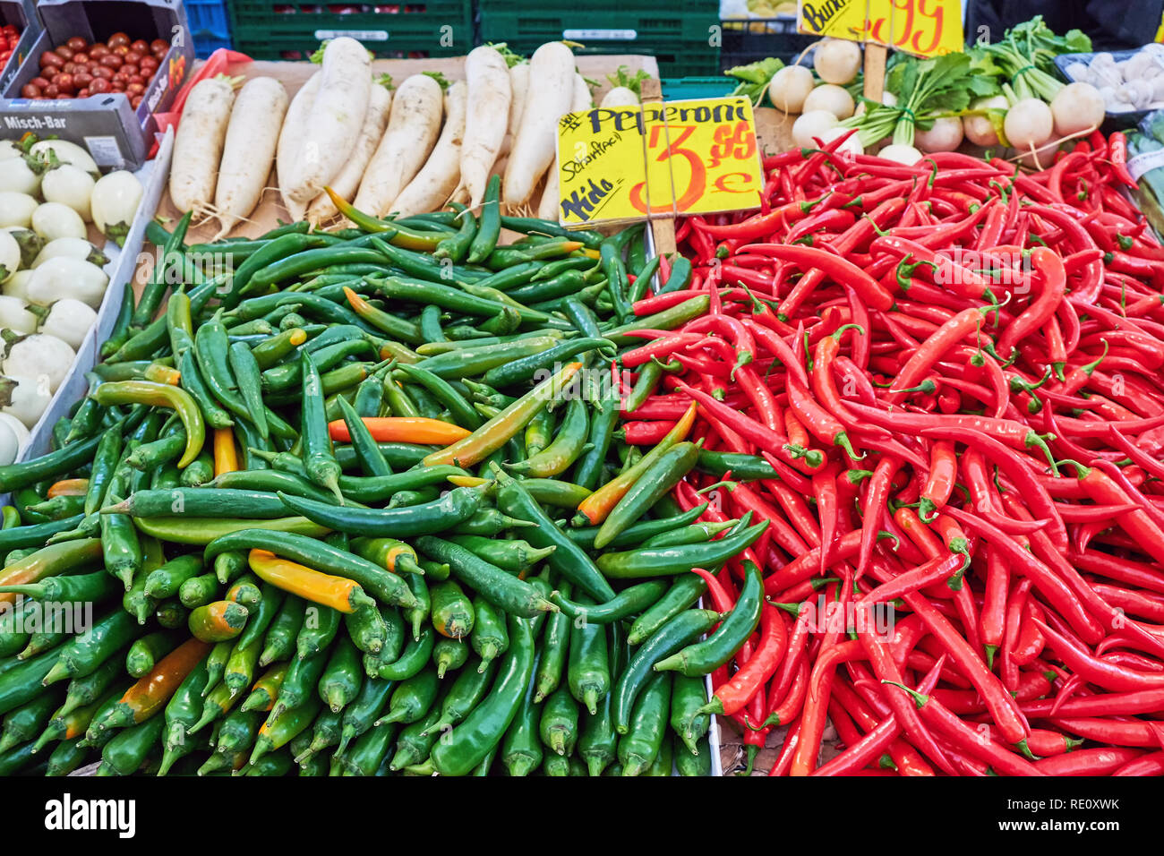 Green and red chilies for sale at a market Stock Photo