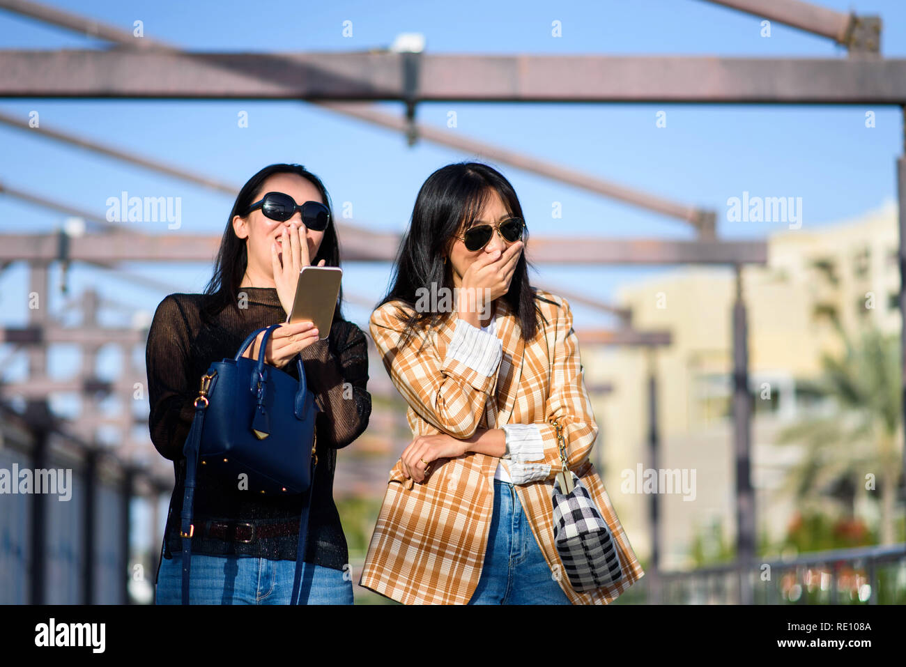 Fashionable girls laughing on the street closeup Stock Photo