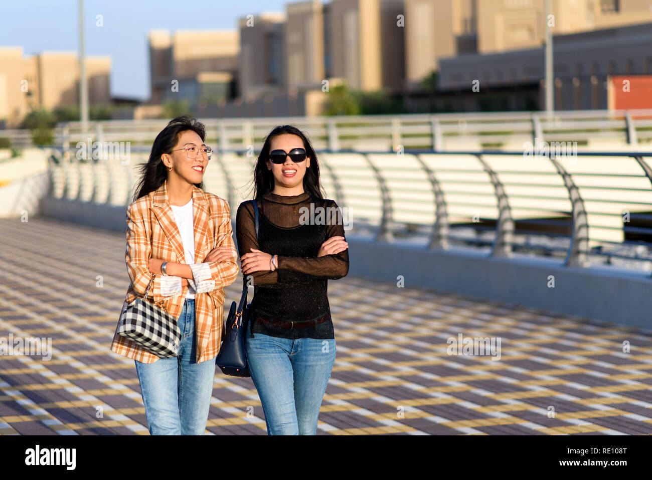 Fashionable girls walking on the street closeup Stock Photo