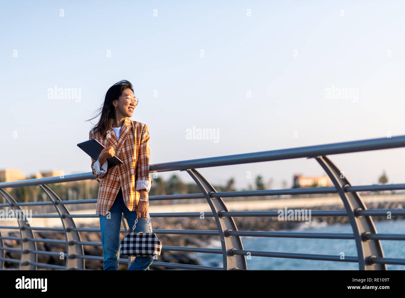 Fashionable Asian woman with laptop outdoors portrait Stock Photo