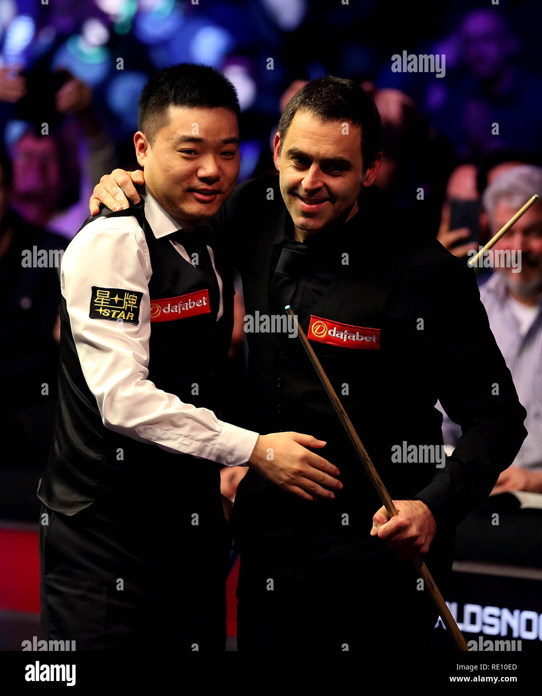 Ronnie OSullivan console Ding Junhui after winning the match during day seven of the 2019 Dafabet Masters at Alexandra Palace, London Stock Photo