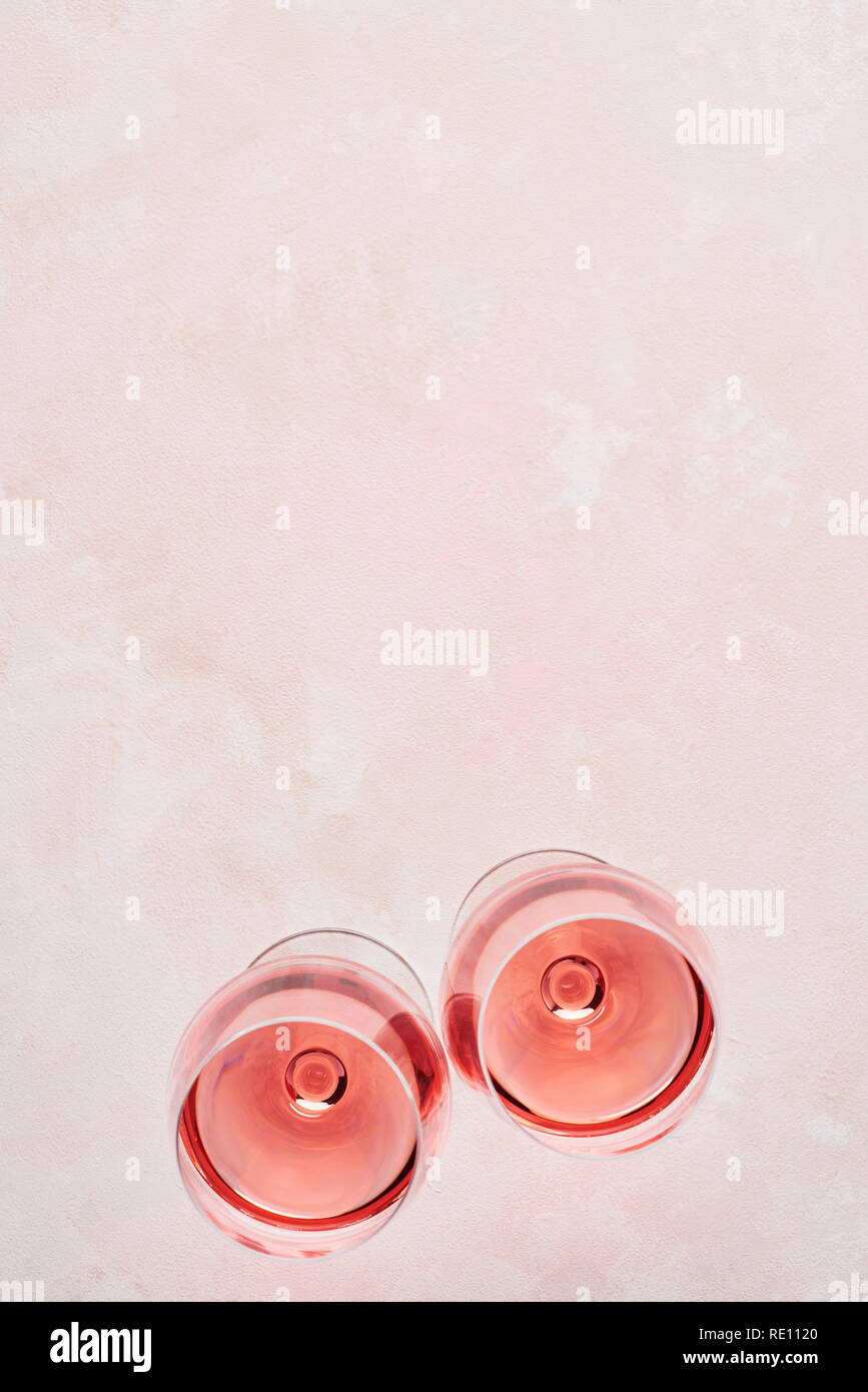 Summer drink. Glass of rose wine on pink background with copy space for text. Top view. Stock Photo
