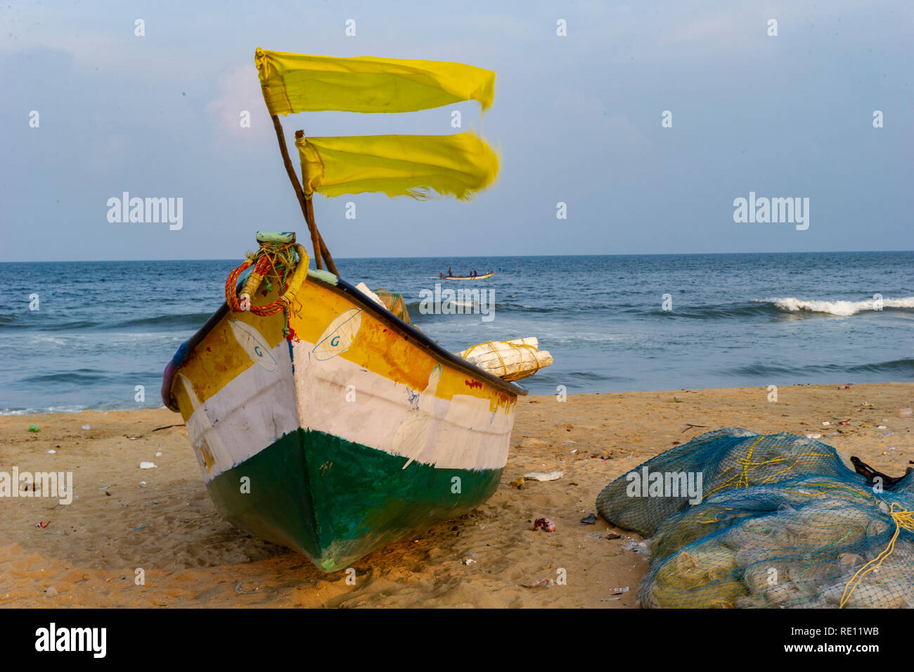 Fishing boats with fluttering flags on Marina Beach, Chennai, India Stock Photo