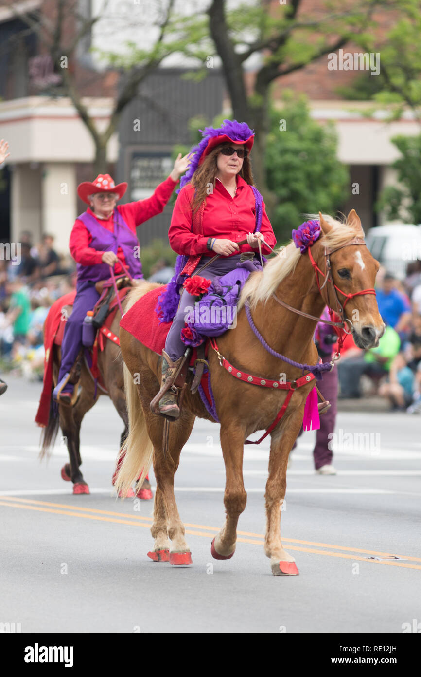Louisville, Kentucky, USA - May 03, 2018: The Pegasus Parade, Women wearing red cowboy hats, riding horses down W Broadway Stock Photo