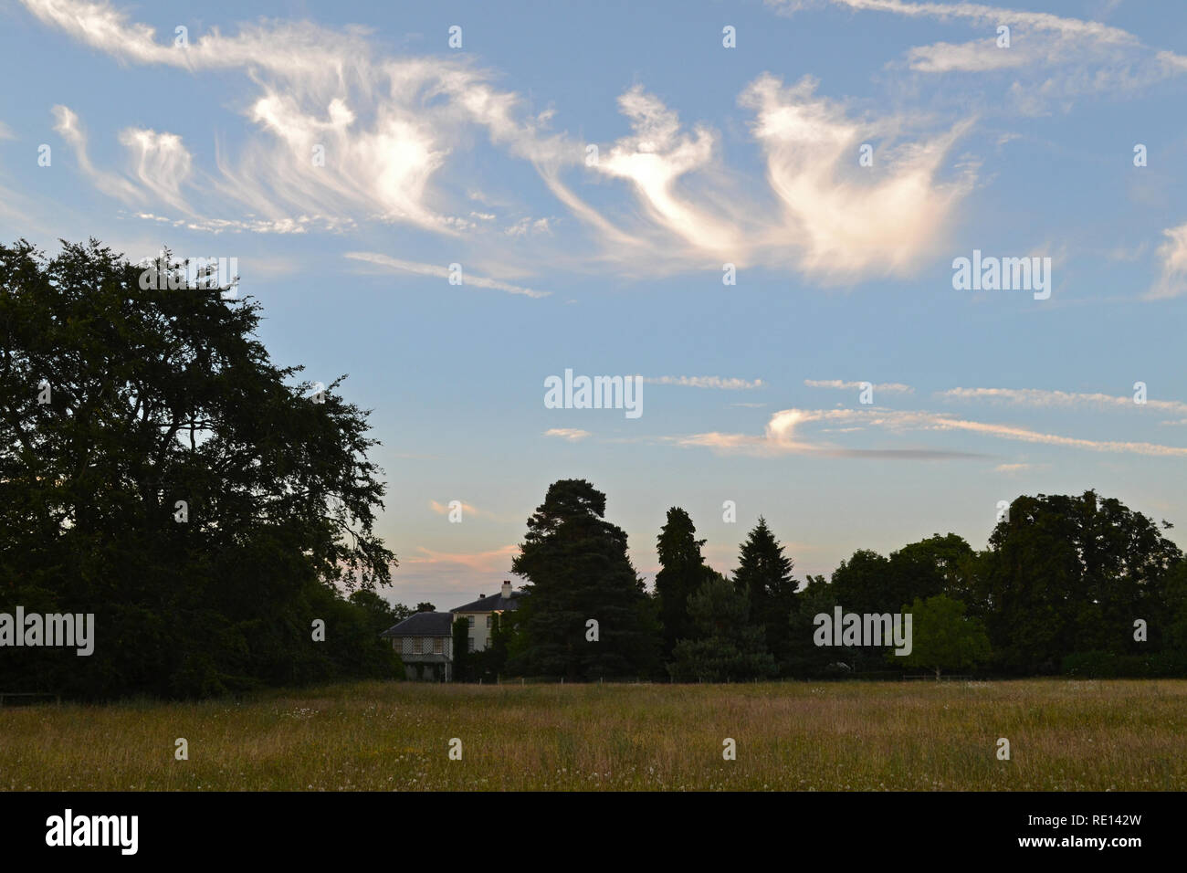 Beautiful summer evening. Cirrus clouds over Down House, Downe, Kent, England. Charles Darwin lived at the house for many years Stock Photo