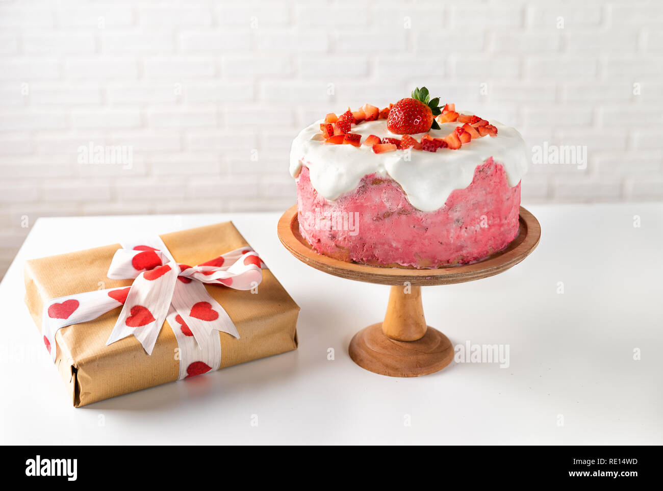 Strawberry cake with gift box on white Stock Photo