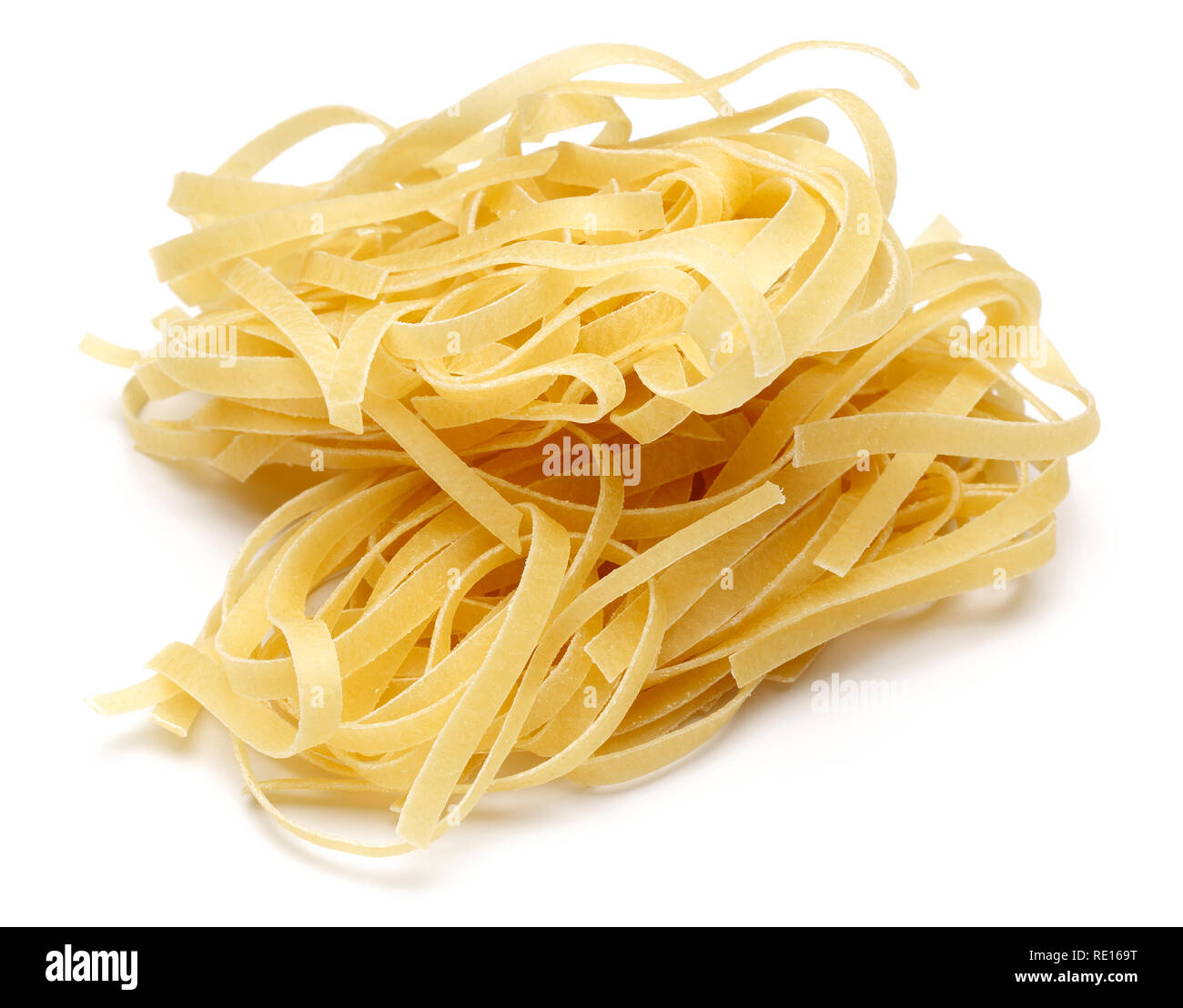 Uncooked tagliatelle pasta isolated on white background Stock Photo