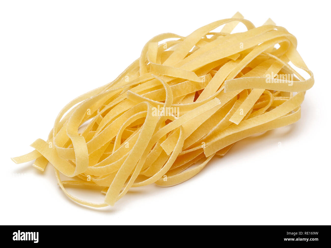 Uncooked tagliatelle pasta isolated on white background Stock Photo
