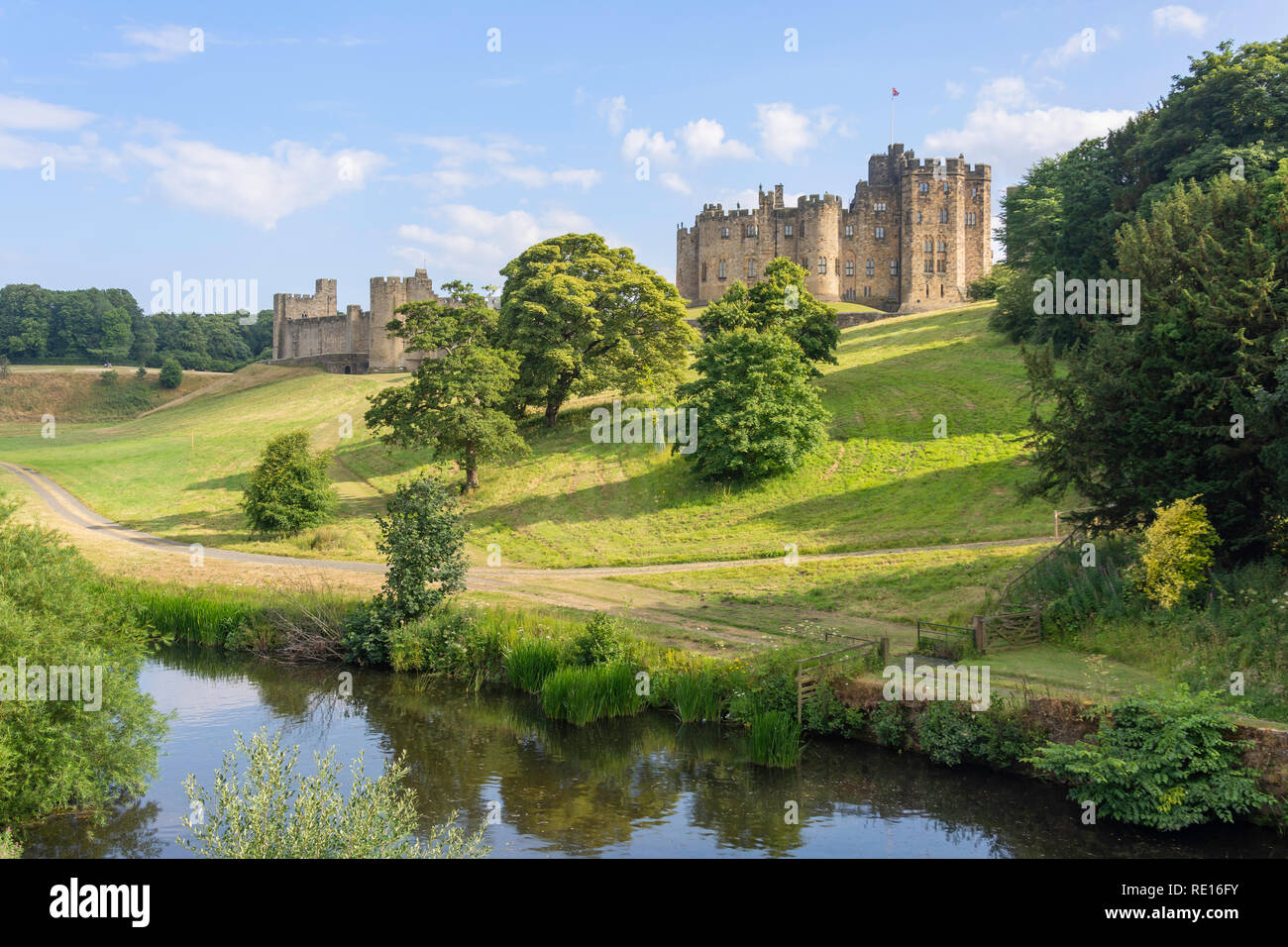 Alnwick Castle across River Aln, Alnwick, Northumberland, England, United Kingdom Stock Photo