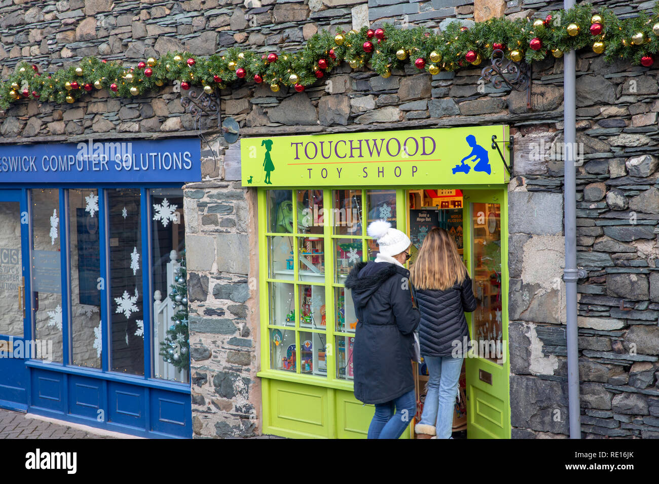 Mother and daughter enter Touchwood toy shop selling wooden toys in