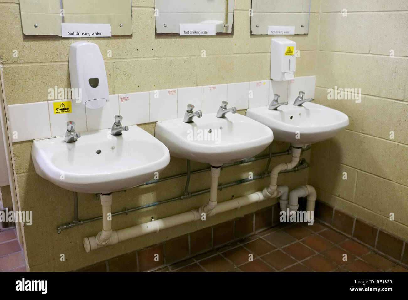 Public toilets wc row of basins caution hot water and do not drink