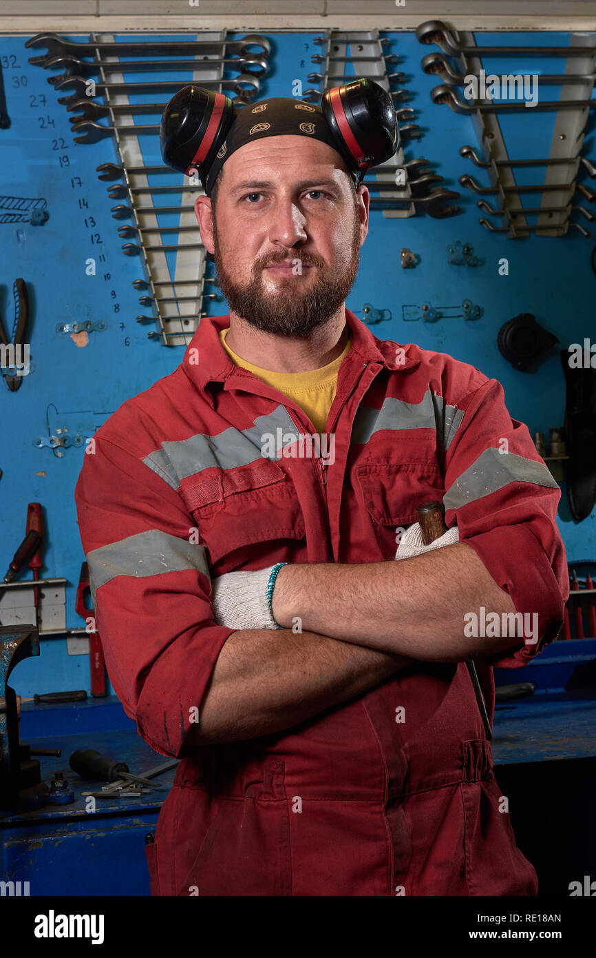 Closeup of auto mechanic. Auto repair service. Working tools background. Auto repair garage. Car