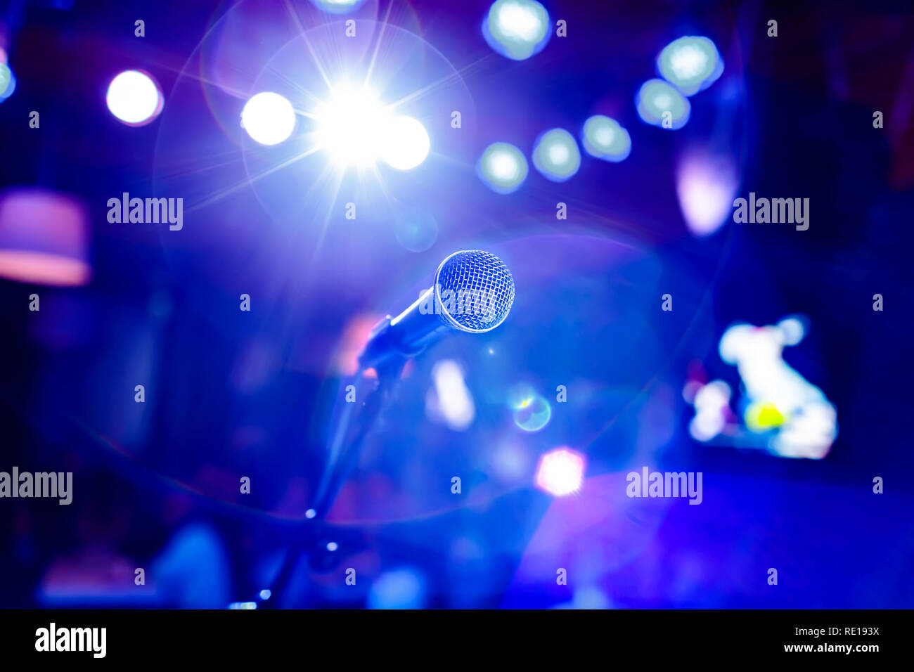 Public performance on stage Microphone on stage against a background of auditorium. Shallow depth of field. Public performance on stage. Stock Photo