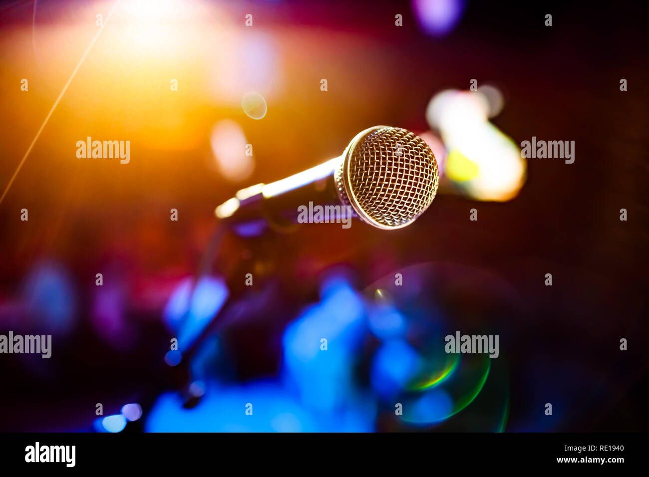 Public performance on stage Microphone on stage against a background of auditorium. Shallow depth of field. Public performance on stage. Stock Photo