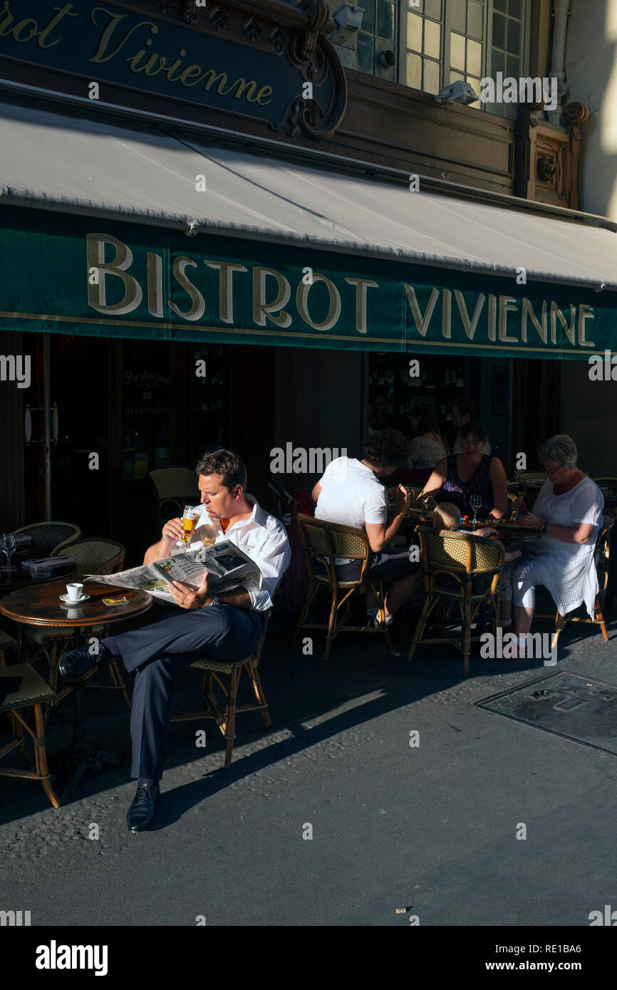 A man drinking a beer and reading a newspaper in a French bistrot, Paris, France Stock Photo