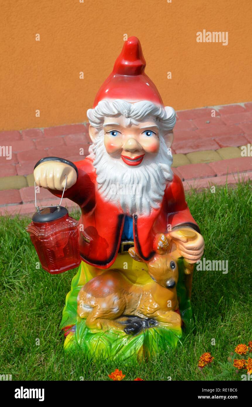 Garden gnome with a lamp Stock Photo