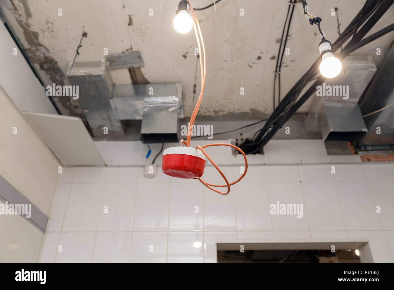 Closeup Installation And Repair Of Electric Cable Smoke Detector
