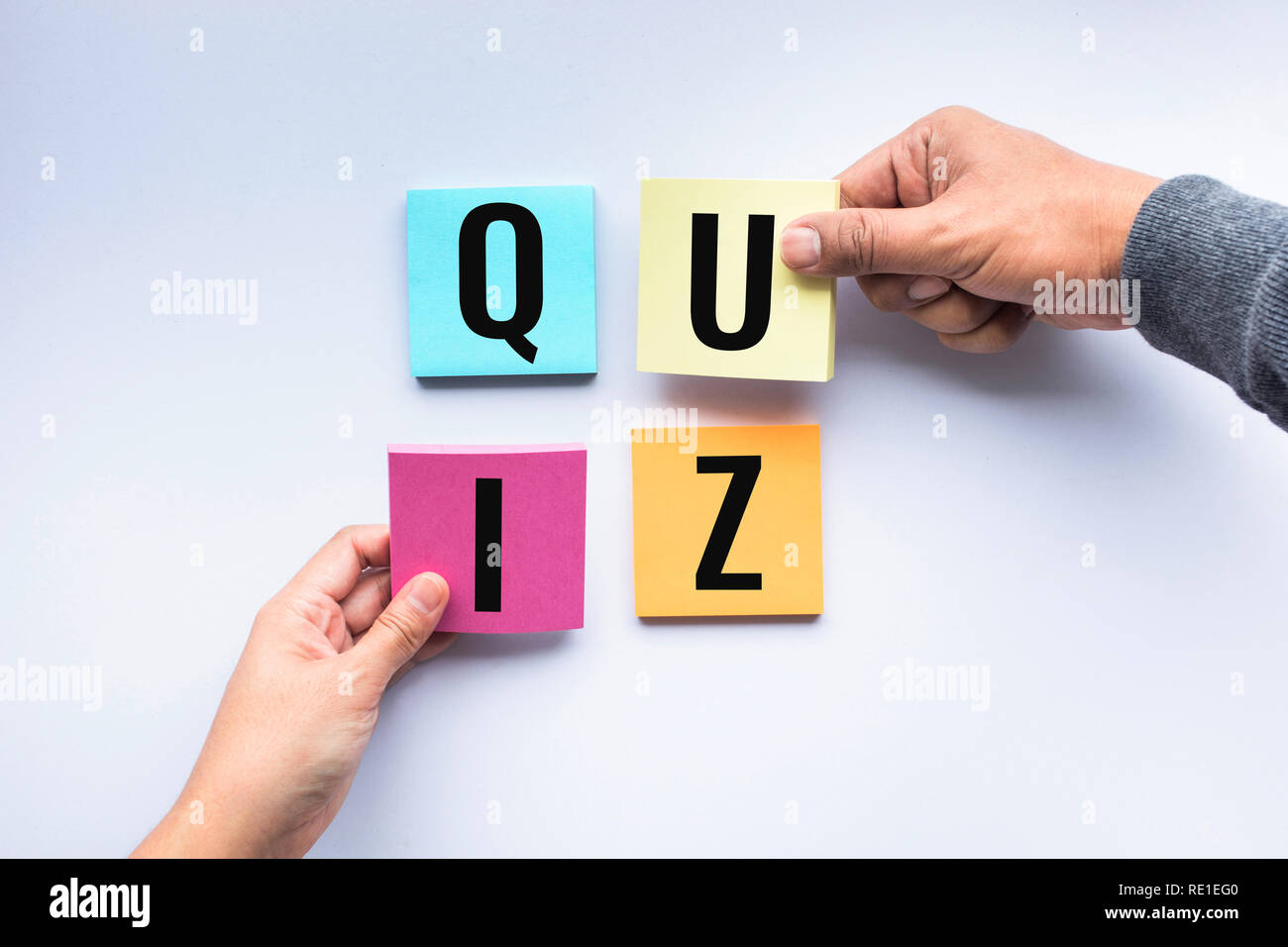 Quiz word on notepaper with human hand Stock Photo