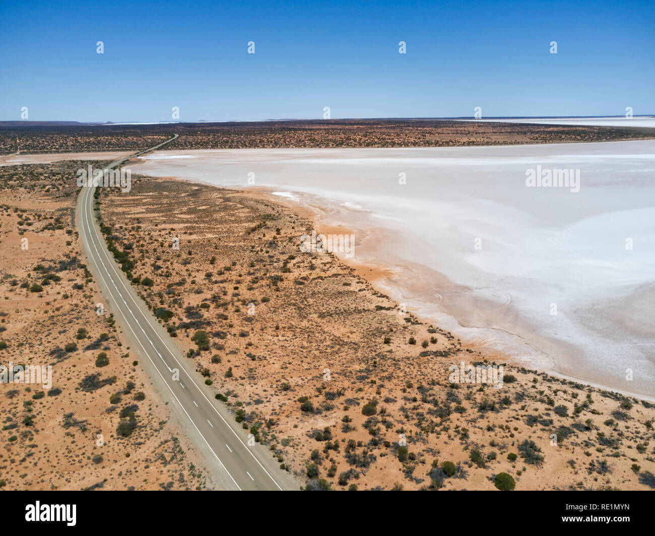 Aerial of the Stuart Highway as it passes salt lakes in the South Australian outback. Stock Photo