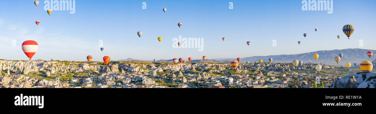 Colorful hot air balloons flying over rock landscape at Cappadocia Turkey Stock Photo