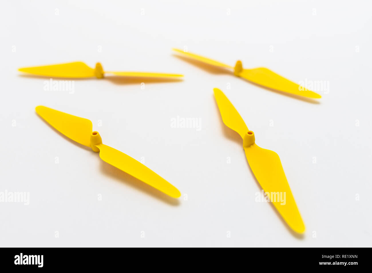 Yellow, plastic propellers for a quadcopter drone, isolated on white background. Stock Photo