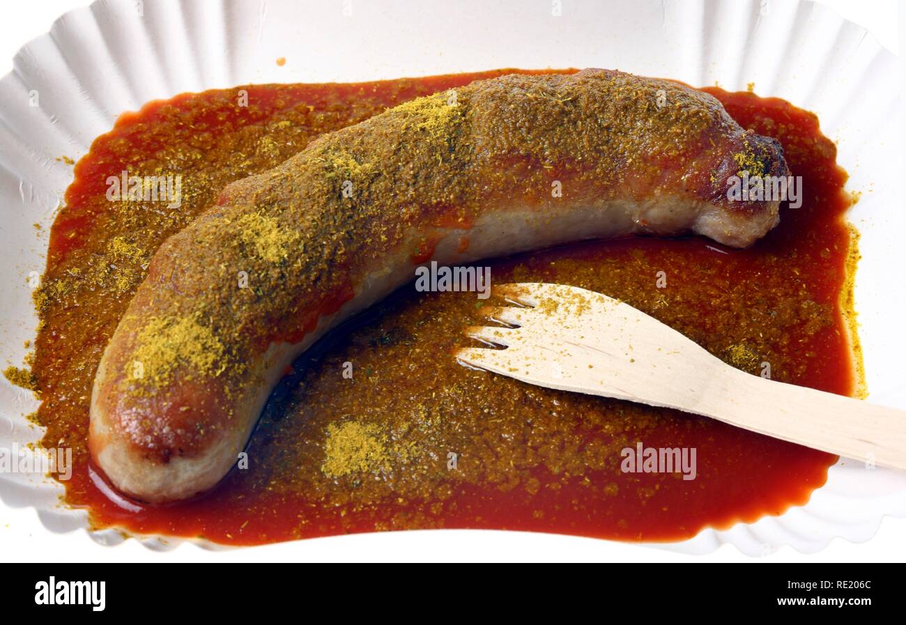 Currywurst with curry sauce on a paper plate, hot pork sausage Stock ...