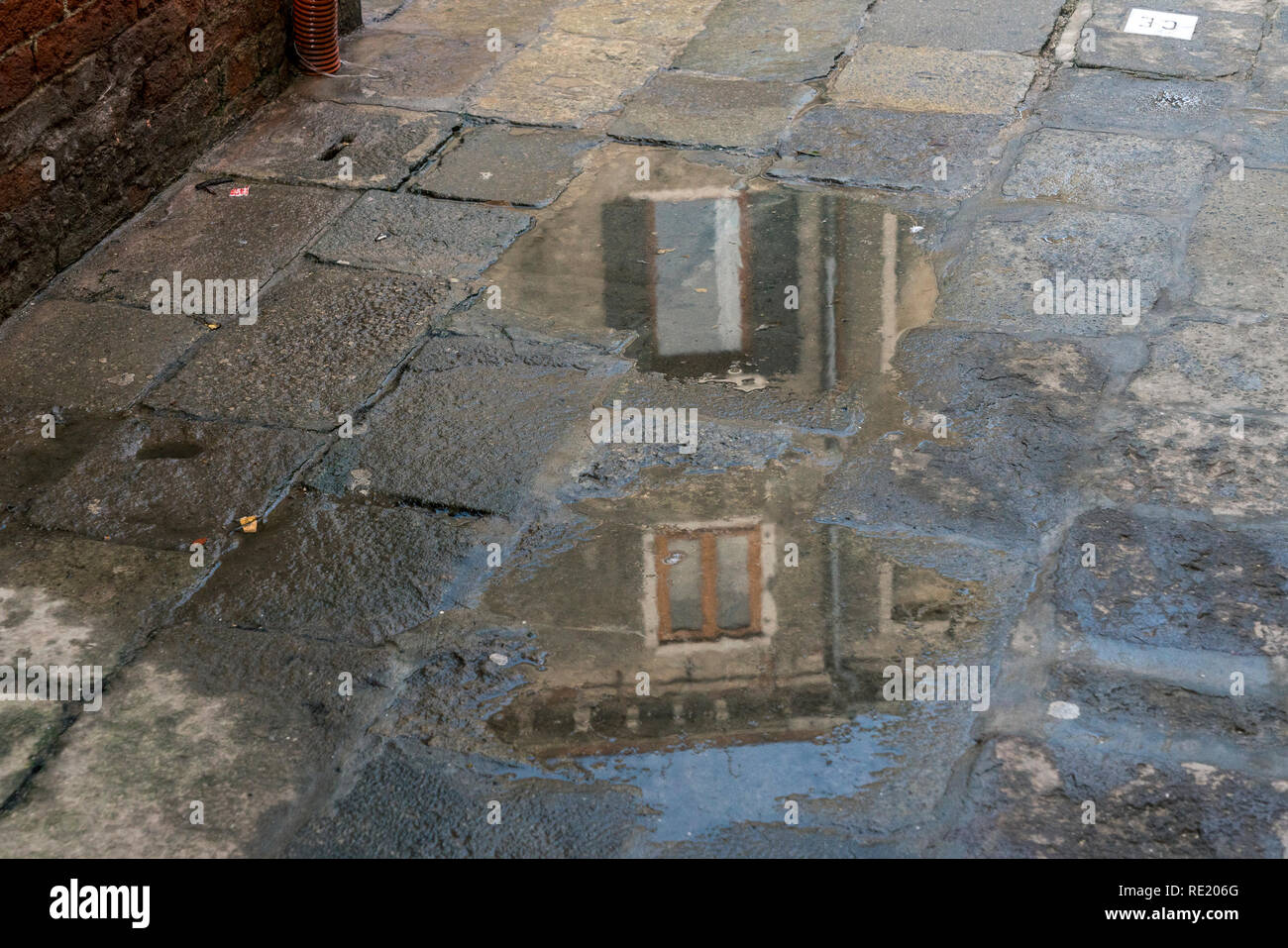 Reflection on puddle in walkway hi-res stock photography and images - Alamy