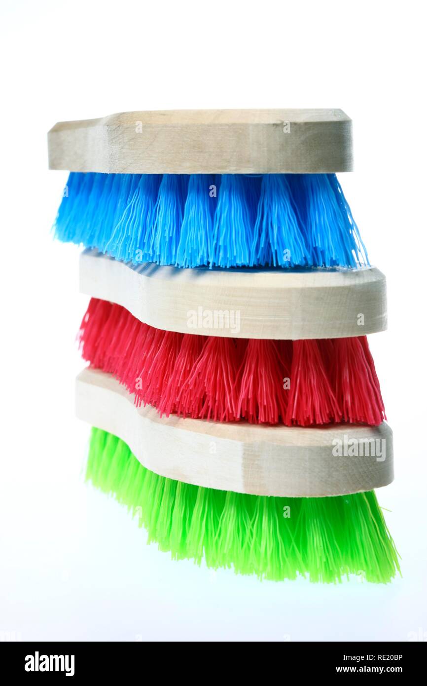 Colourful scrubbing brushes, wooden with plastic bristles Stock Photo