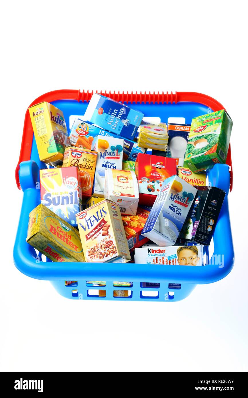 Toy shopping basket filled with mini packaging from a children's shop Stock Photo