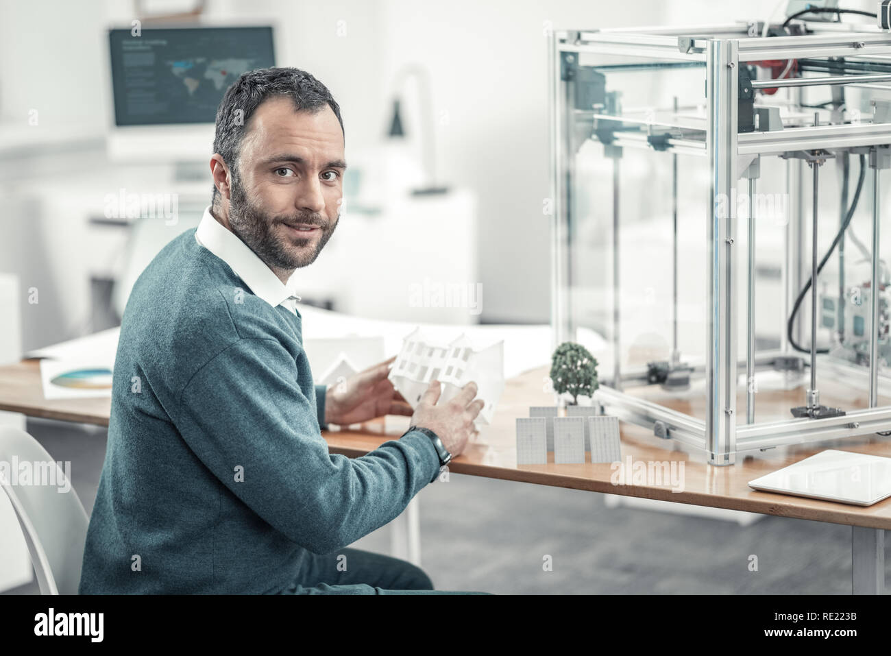 Positive bearded man sitting at the table Stock Photo
