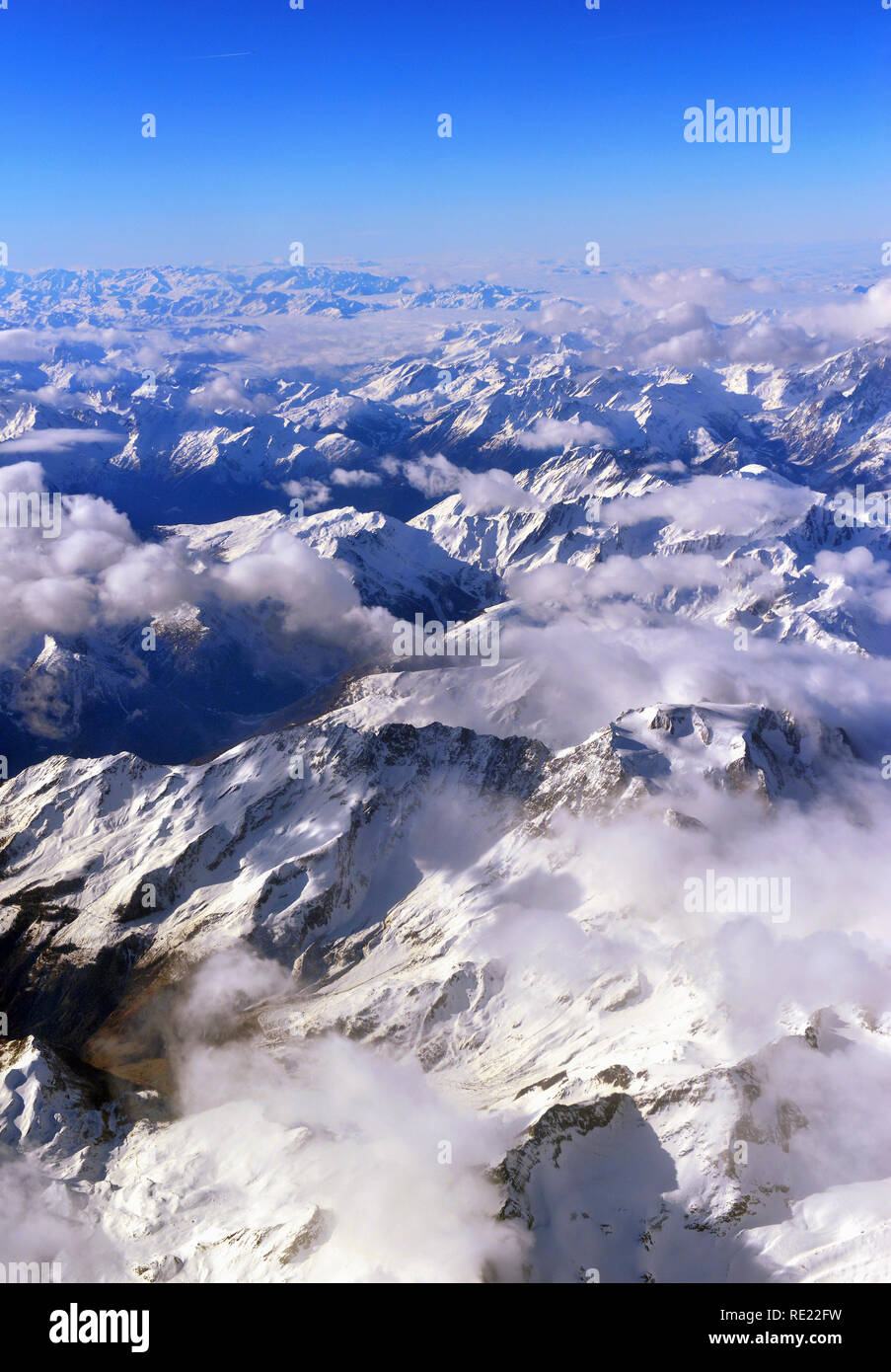 Aerial view of the rugged snow covered mountains of the Alps at the ...