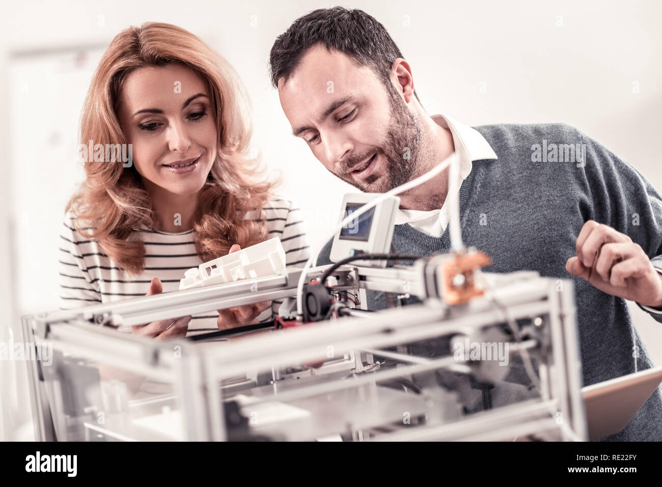 Professional designers watching at white plastic layout Stock Photo