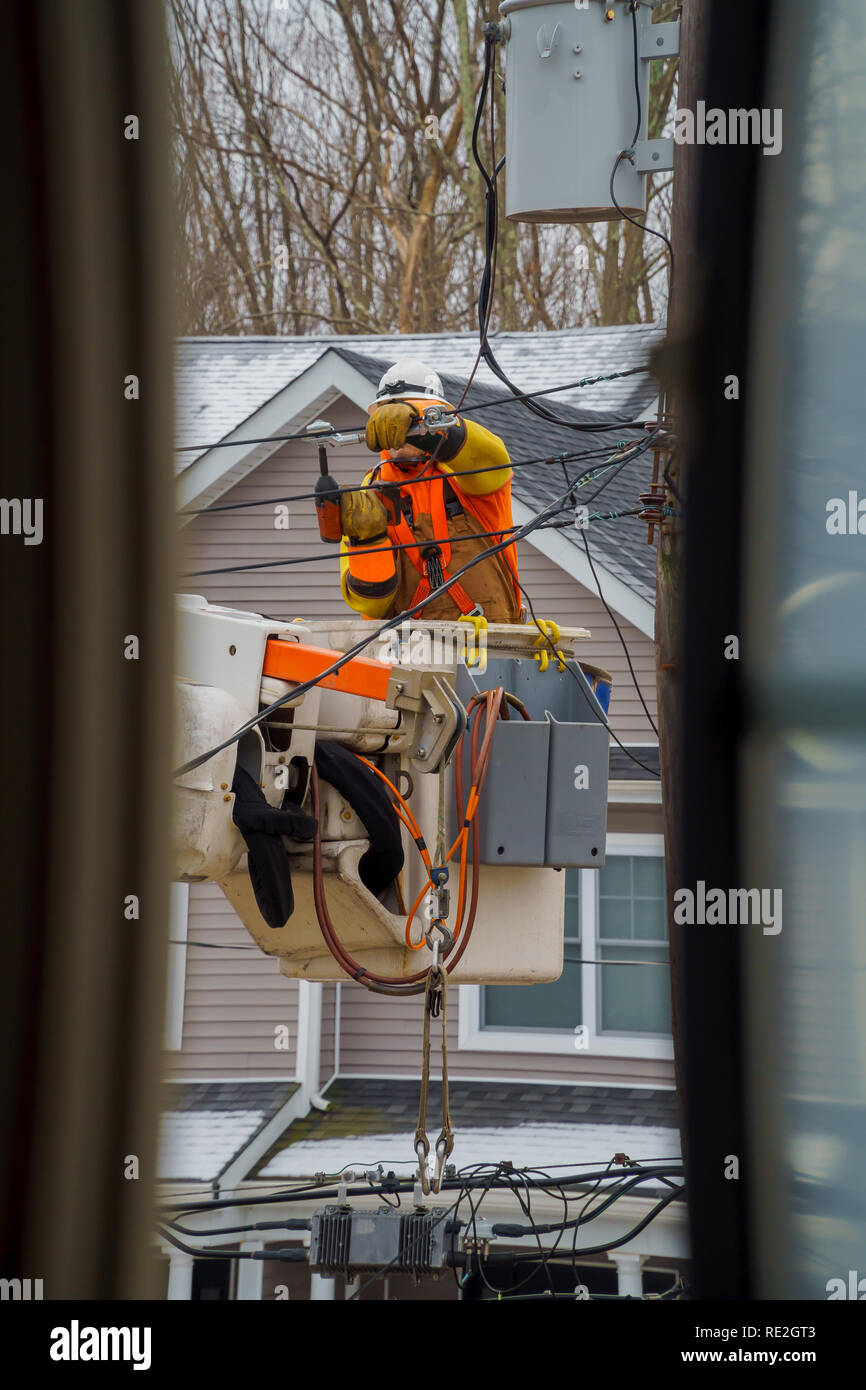 Electric power line crews make repairs long after a snow storm Stock Photo