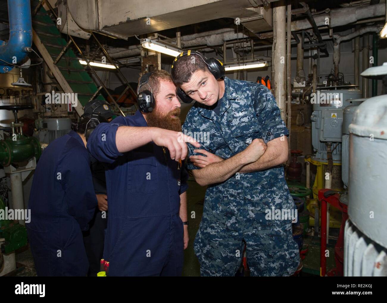 PACIFIC OCEAN (Nov. 12, 2016) – Arleigh Burke-class guided-missile destroyer USS Sampson (DDG 102) sailor Petty officer 3rd Class Brian Duhamel, right, receives a tour of the ship engine space from Royal New Zealand Navy Chief Andrew Walsh aboard Her Majesty’s New Zealand Ship Endeavour. Sampson will report to U.S. Third Fleet, headquartered in San Diego, while deployed to the Western Pacific as part of the U.S. Pacific Fleet-led initiative to extend the command and control functions of Third Fleet into the region. Stock Photo