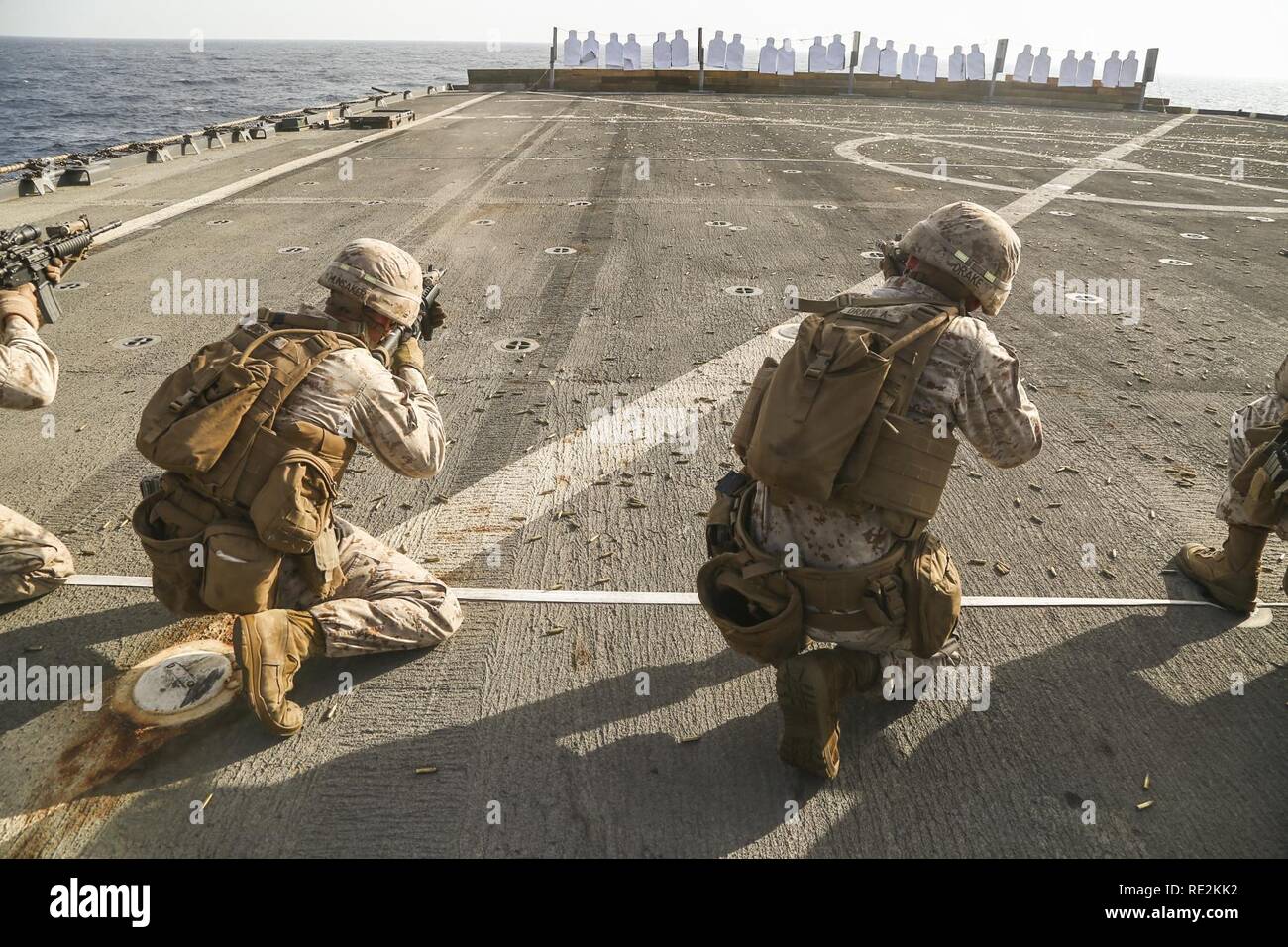 RED SEA (Nov. 14, 2016) Marine Cpl. Joseph M. Hunsaker, left, and Cpl. Daniel K. Drake, right, with Charlie Company, Battalion Landing Team, 1st Battalion, 6th Marine Regiment, 22nd Marine Expeditionary Unit (MEU) aim at targets during a combat marksmanship range aboard the amphibious dock landing ship USS Whidbey Island (LSD 41), Nov. 14, 2016. 22nd MEU, deployed with the Wasp Amphibious Ready Group, is maintaining regional security in the U.S. 5th Fleet area of operations. Stock Photo