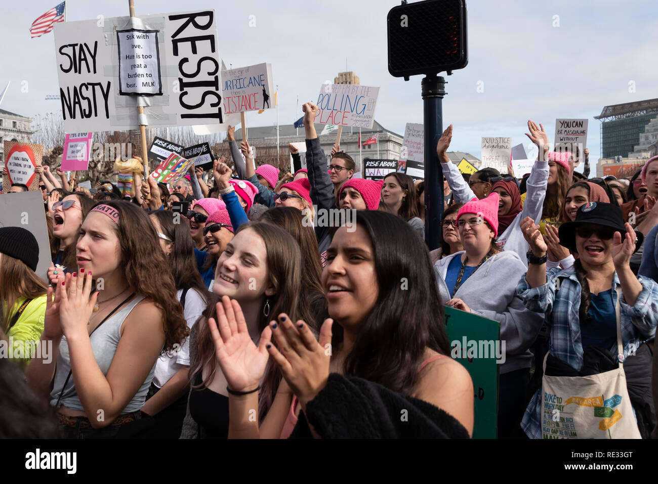 San Francisco, USA. 19th January, 2019. The Women's March San Francisco begins with a rally at Civic Center Plaza in front of City Hall. Young women clap near the front of a cheering crowd during the rally. Credit: Shelly Rivoli/Alamy Live News Stock Photo