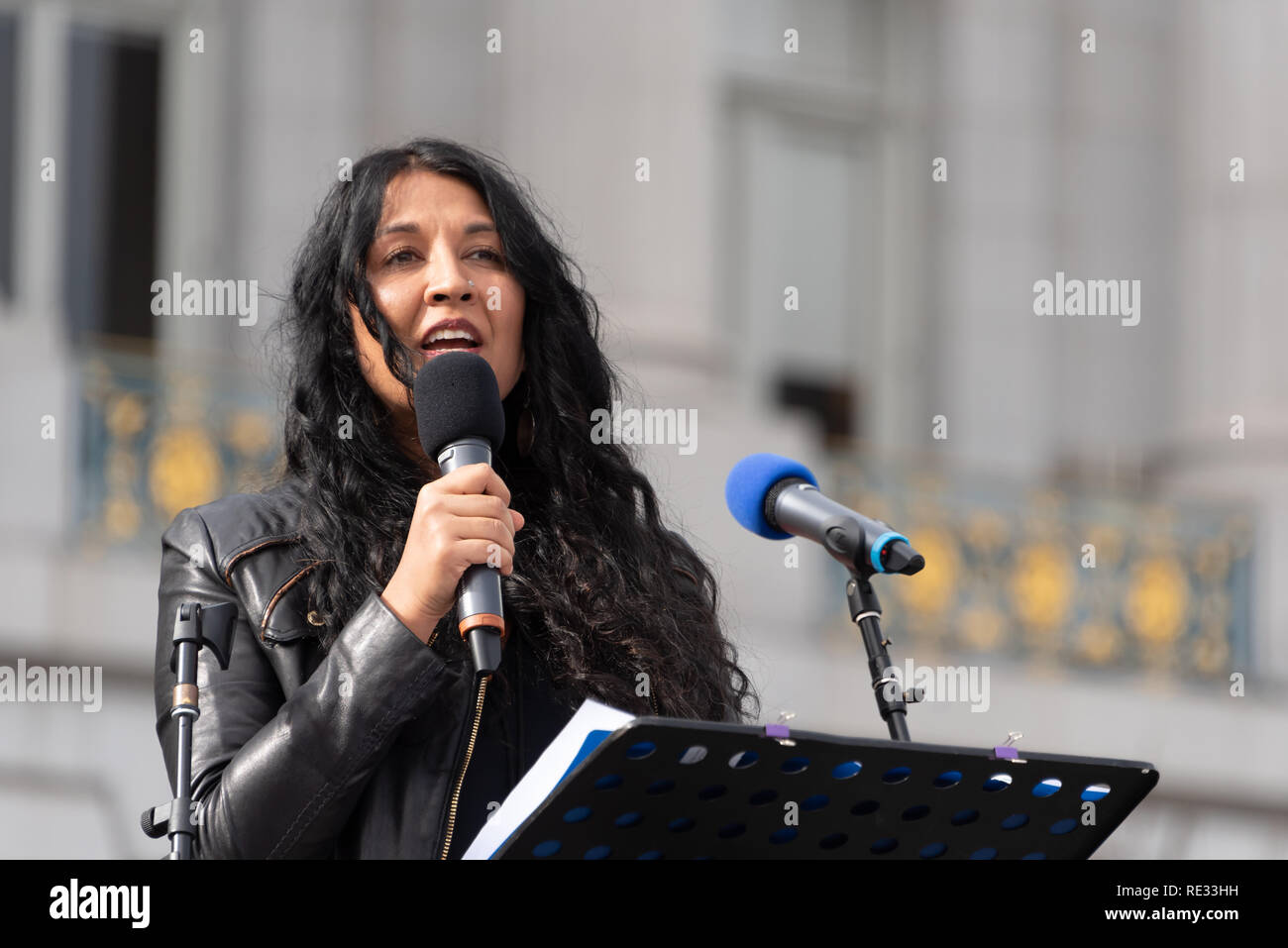 San Francisco, USA. 19th January, 2019. The Women's March San Francisco begins with a rally at Civic Center Plaza in front of City Hall. Writer and consultant Natasha Singh, who works closely with Asha Rising, Freedom forward, and Center for Domestic Peace, addresses the crowd. Her writing has appeared in The Atlantic, The New York Times and several anthologies. Credit: Shelly Rivoli/Alamy Live News Stock Photo