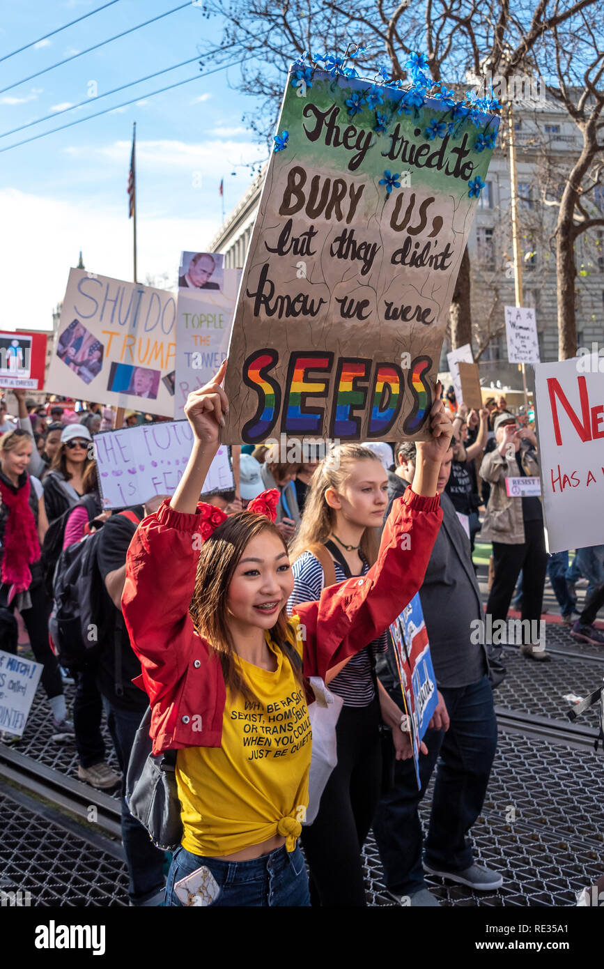 San Francisco, USA. 19th January, 2019. The Women's March San Francisco proceeds down Market Street. A young woman smiles as she holds a sign reading: 'They tried to bury us, but they didn't know we were seeds.' Credit: Shelly Rivoli/Alamy Live News Stock Photo