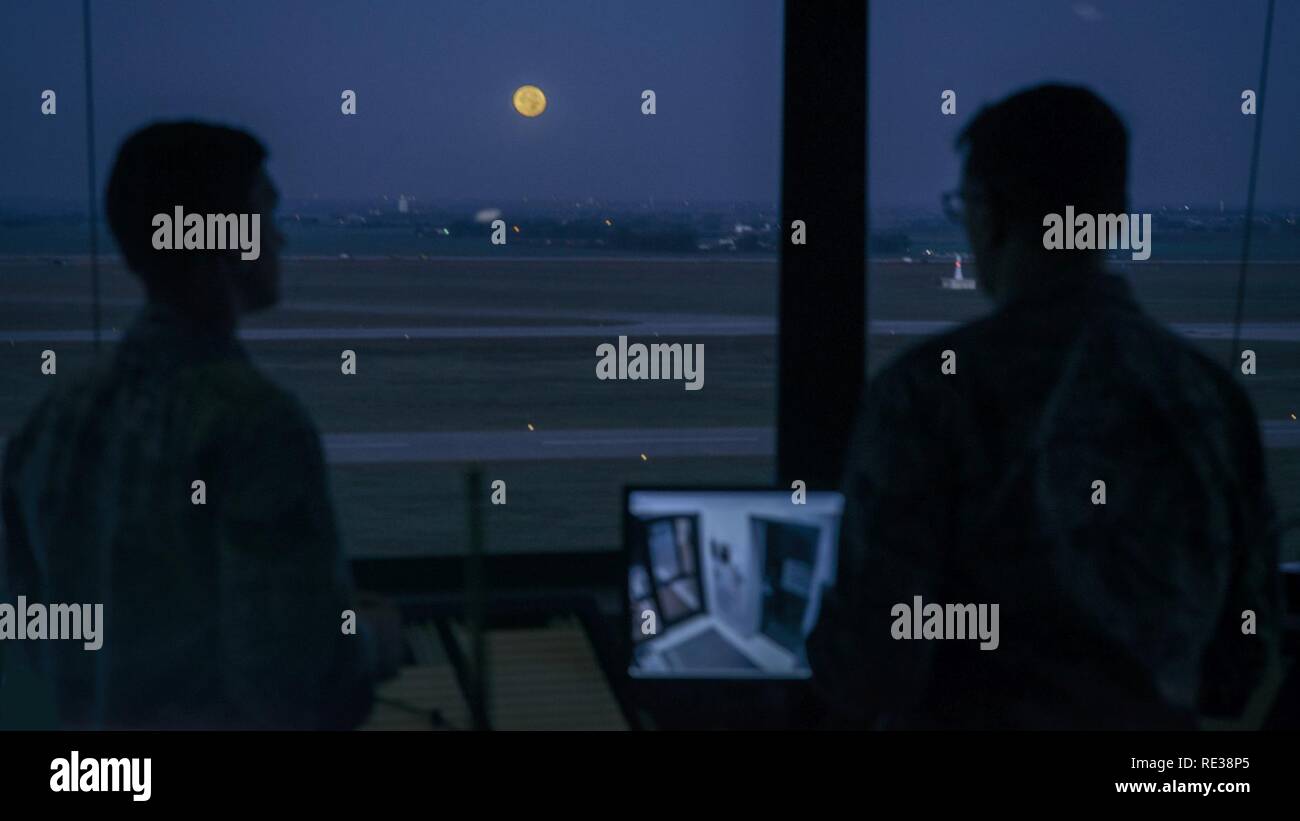 Air traffic controllers from the 71st Operations Support Squadron prepare for their day under a Super Moon at Vance Air Force Base, Oklahoma, Nov. 14. One of only four bases in the Air Force that has a primary pilot training mission, Vance averages more flights per hour than many major commercial airfields. Stock Photo
