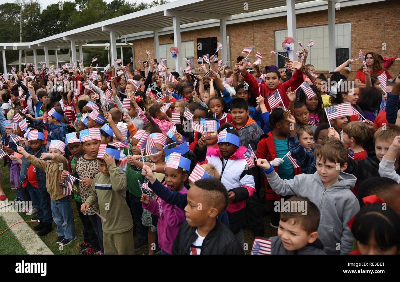 Students at Jeff Davis Elementary School wave their flags during a