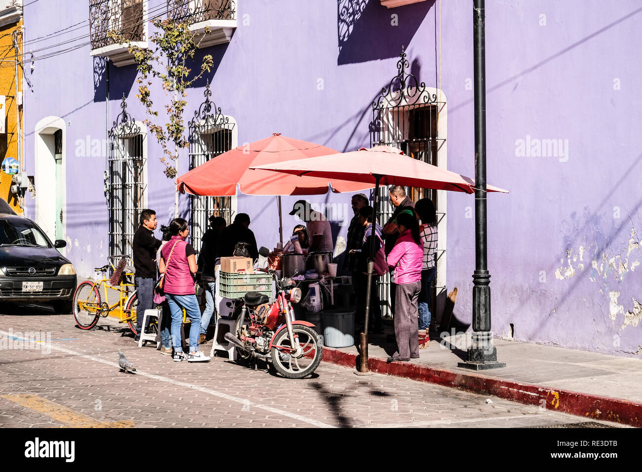 Mexican locals gather around a street food vendor hi-res stock