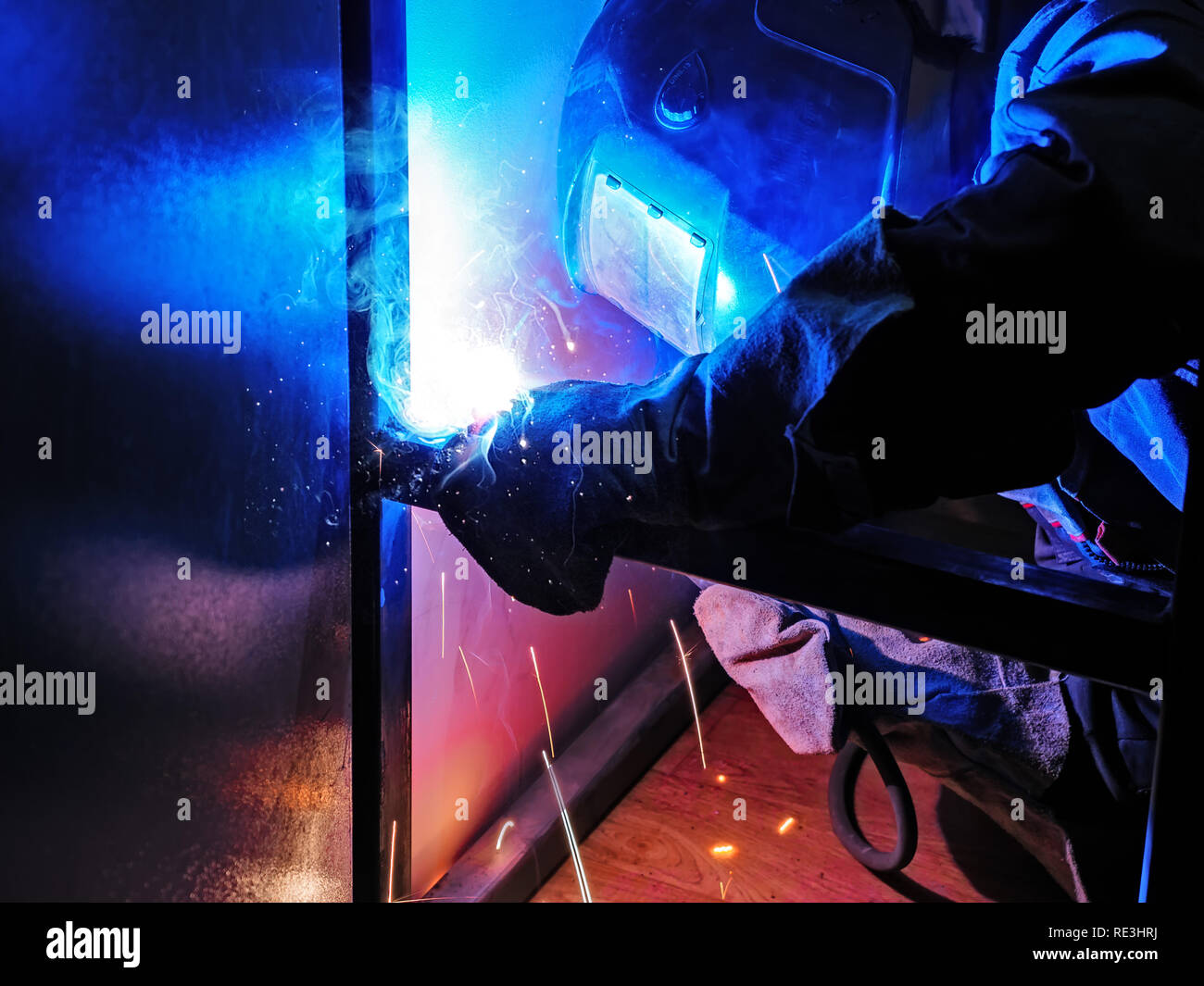 Welder Worker Performs Jump Welding. Worker Welder Performs ArcWelding