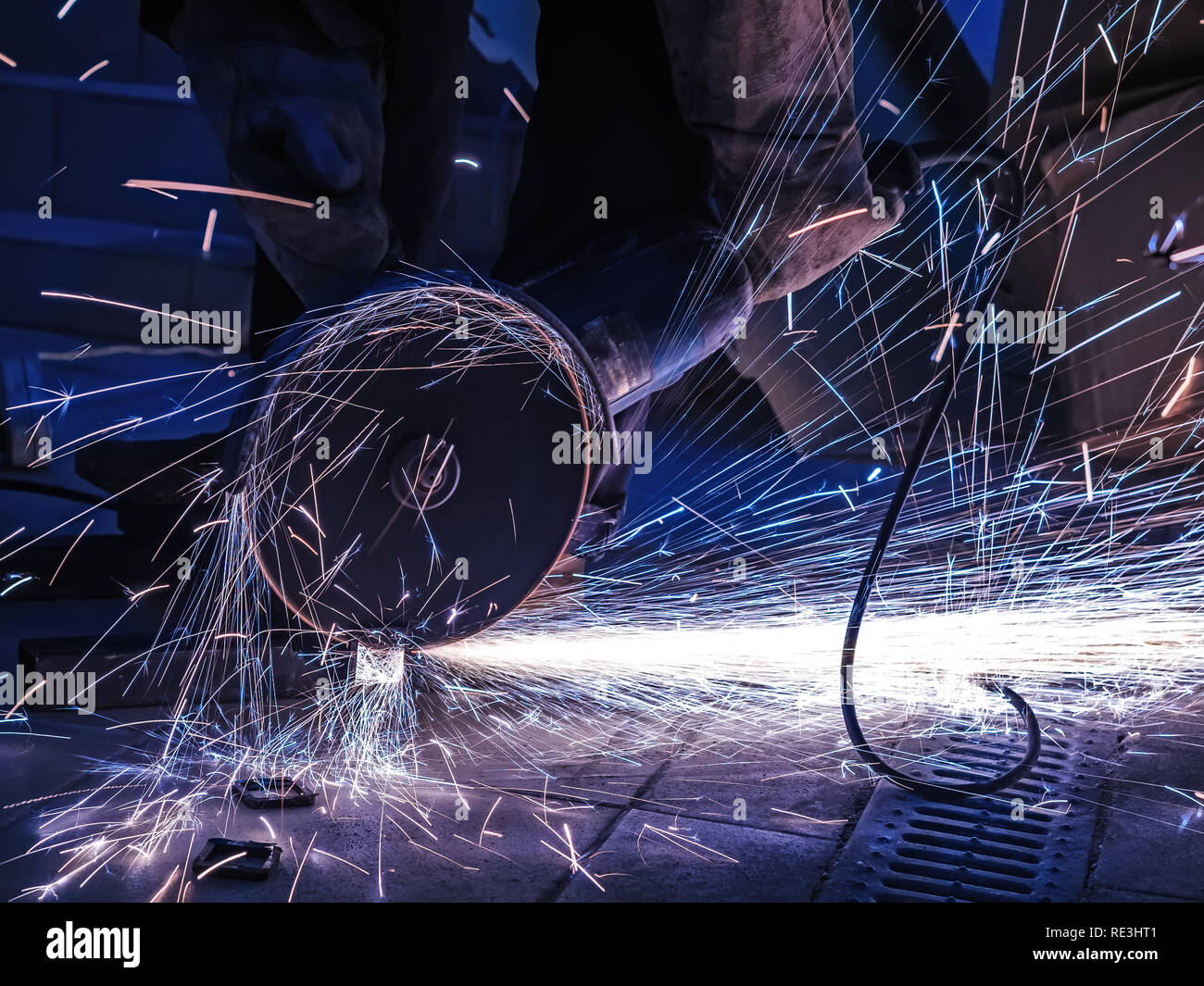 Sparks during cutting of metal angle grinder. A lot of glowing sparks flies around the rotating