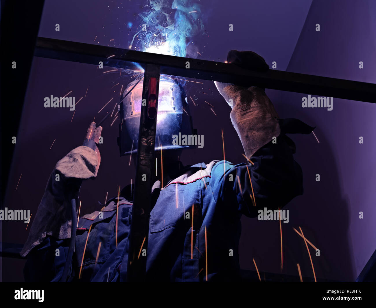 Welder Worker Performs Jump Welding. Worker Welder Performs ArcWelding