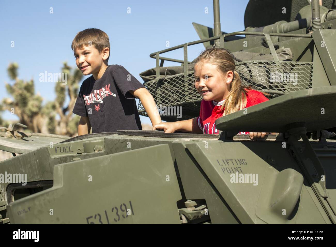 Keelan Vincent, 8, and Naomi Brunk, 10, explore a Light Armored Vehicle