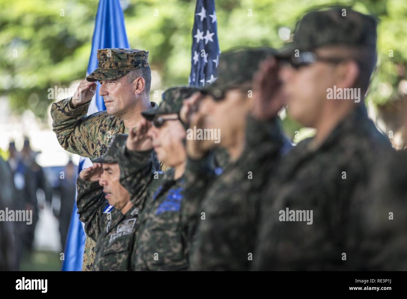 U.S. Marine Col. Thomas Prentice, commanding officer for Special Purpose Marine Air-Ground Task Force – Southern Command, salutes during the playing of the American and Honduran national anthems and the Marines’ Hymn during a farewell ceremony aboard Soto Cano Air Base, Honduras, Nov. 10, 2016. The ceremony was conducted to bid farewell to the Marines and sailors of SPMAGTF-SC and recognize all the work they accomplished alongside their Honduran counterparts throughout their six month rotation in Central America. Stock Photo