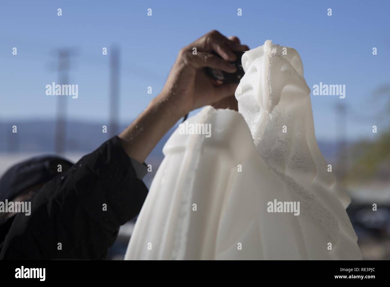 A Sodexo employee puts the finishing touches on an American Bald Eagle ice sculpture during